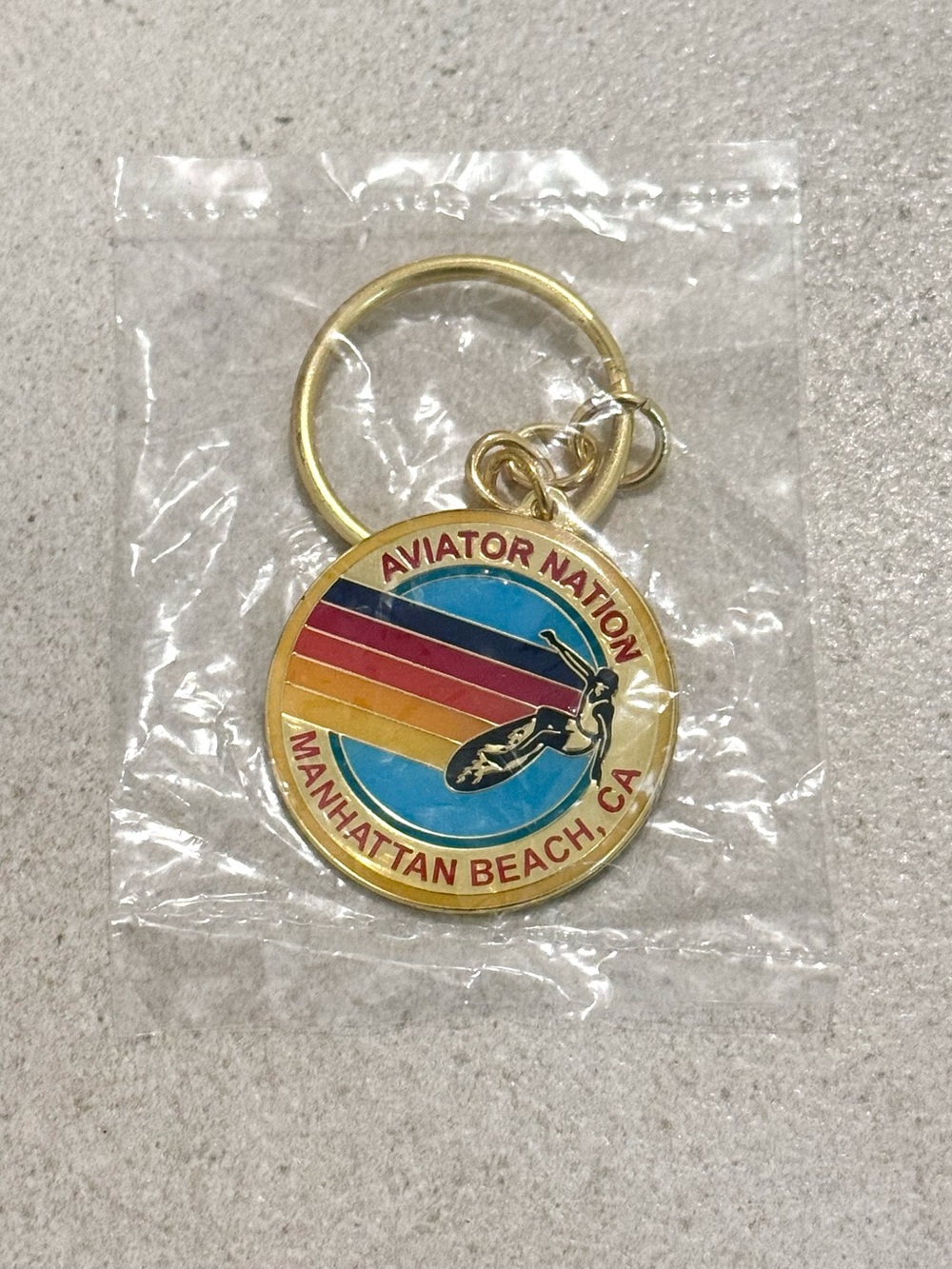 Aviator Nation Gold Enamel Keychain with Rainbow Stripes